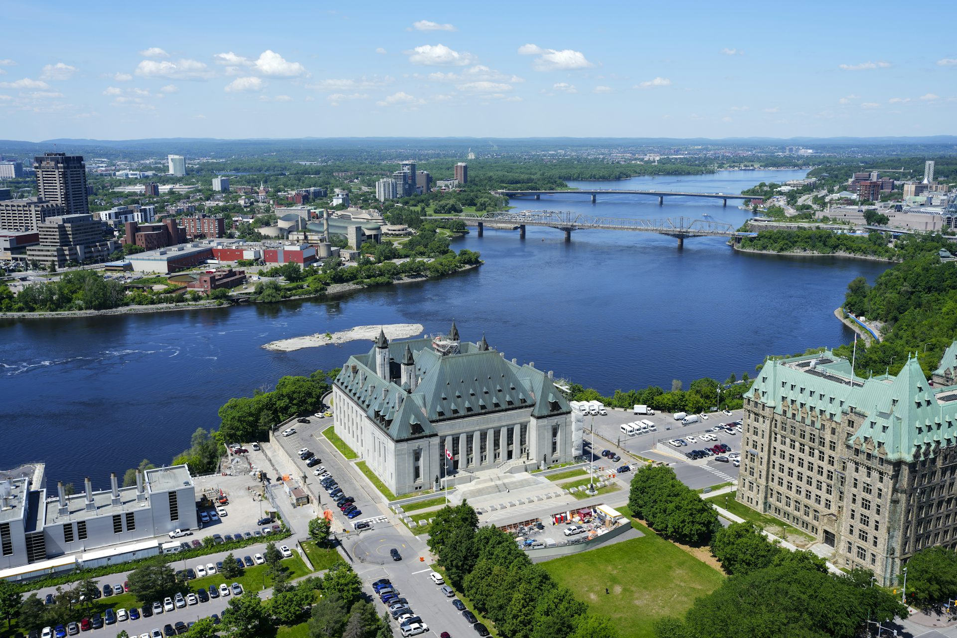 An aerial view of a stone building on the banks of a river.