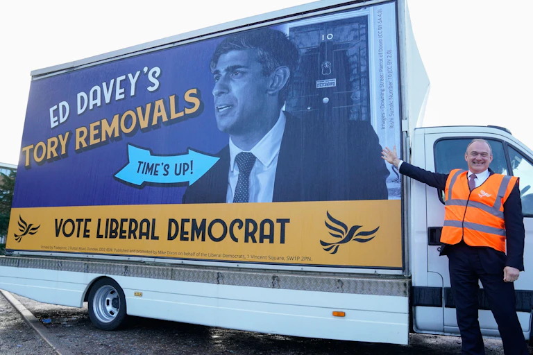 Ed Davey standing next to a can with a picture of Rishi Sunak on its side, with the words 'Ed Davey's Tory Removals'.