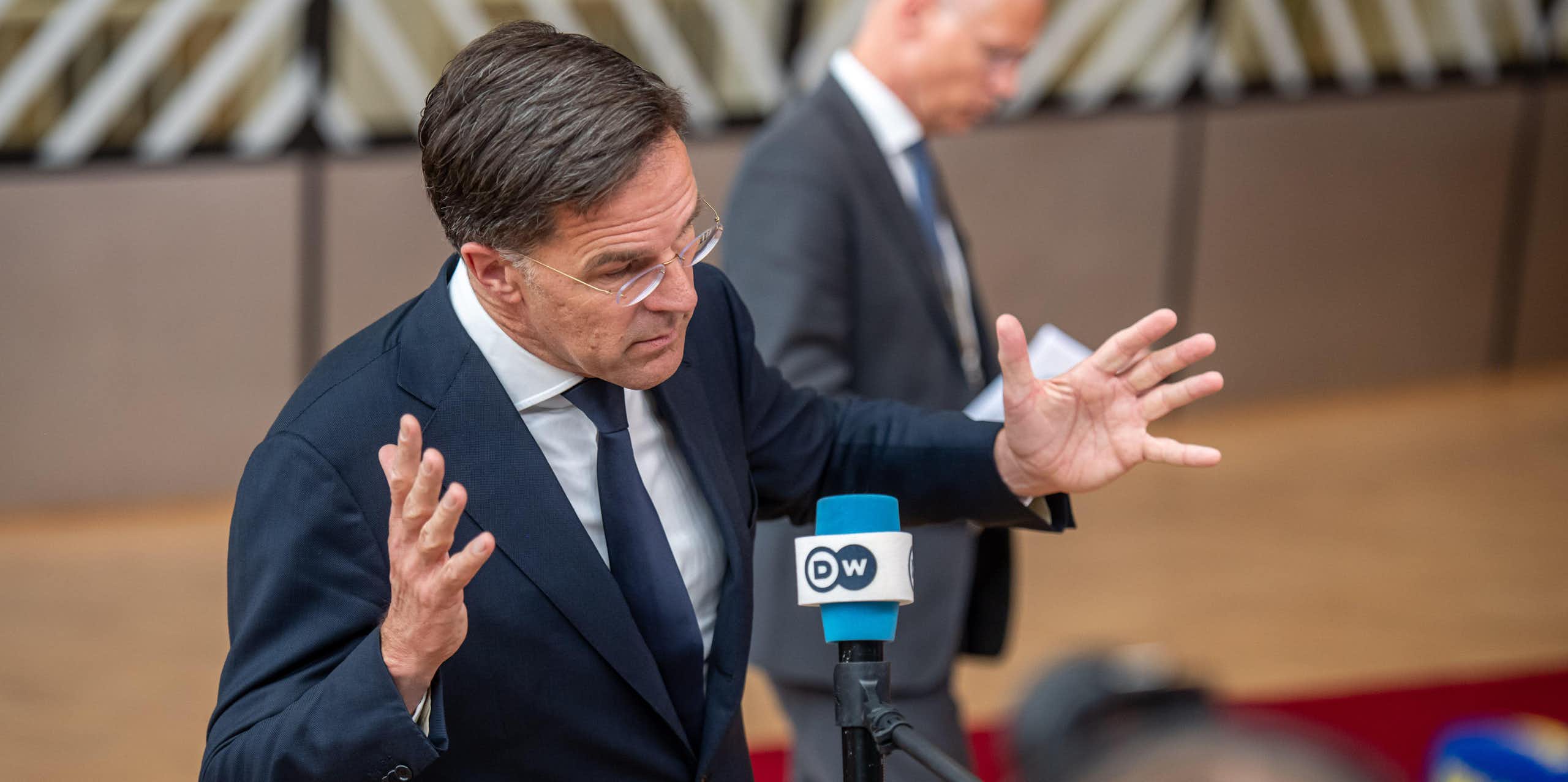Former Dutch prime minister Mark Rutte waves his arms in the air.