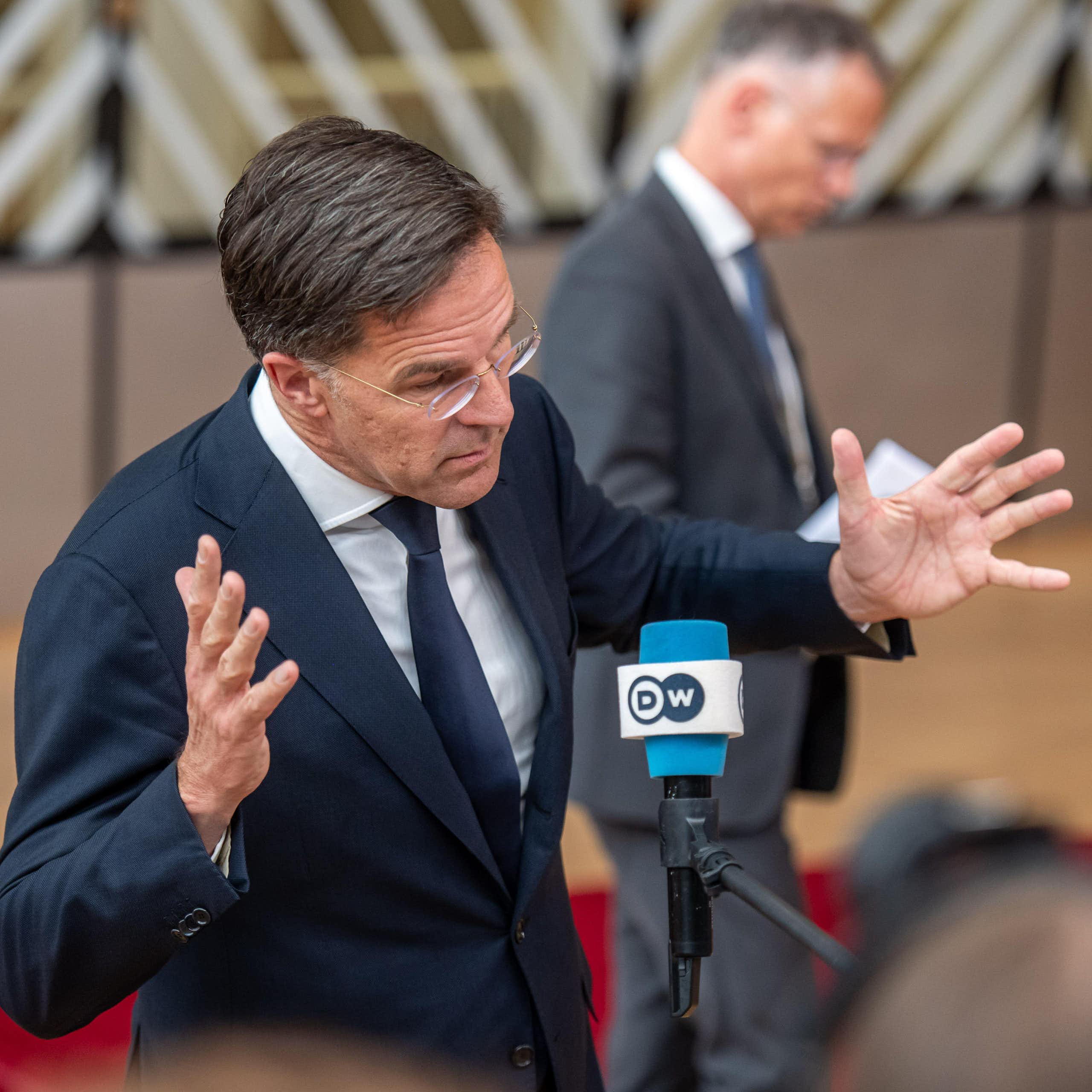 Former Dutch prime minister Mark Rutte waves his arms in the air.