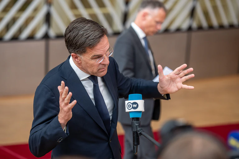 Former Dutch prime minister Mark Rutte waves his arms in the air.