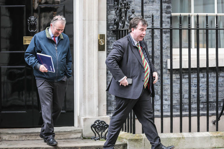 Craig Williams and another man walking out of 10 Downing Street.