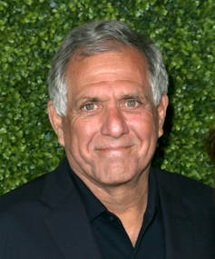 A gray haired, tanned man in a black shirt.