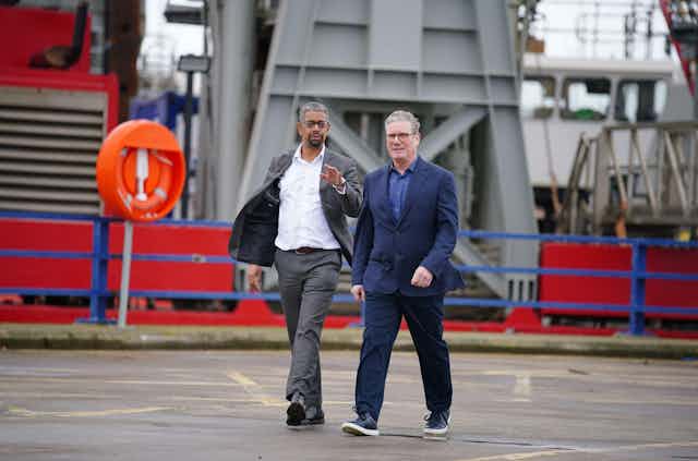 Keir Starmer and Vaughan Gething  walking in a port.