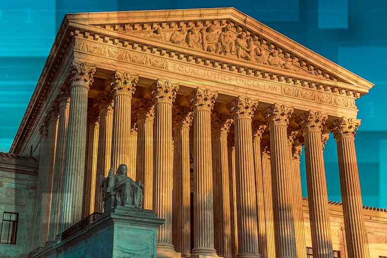 A large, white pillared building that has 'EQUAL JUSTICE UNDER LAW' carved under its pediment.
