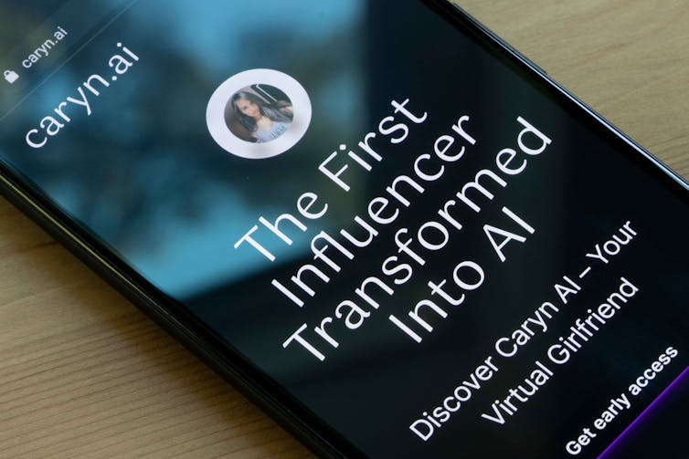 Photo of a photo showing the CarynAI webpage. Photo of a photo showing the CarynAI webpage.