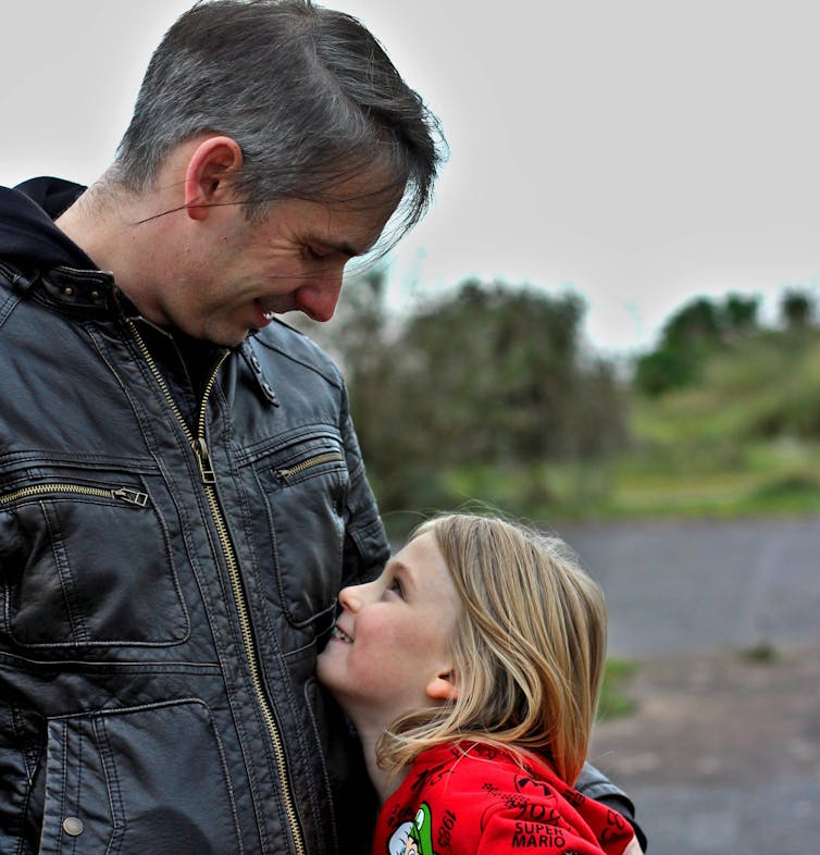 Dad hugs child