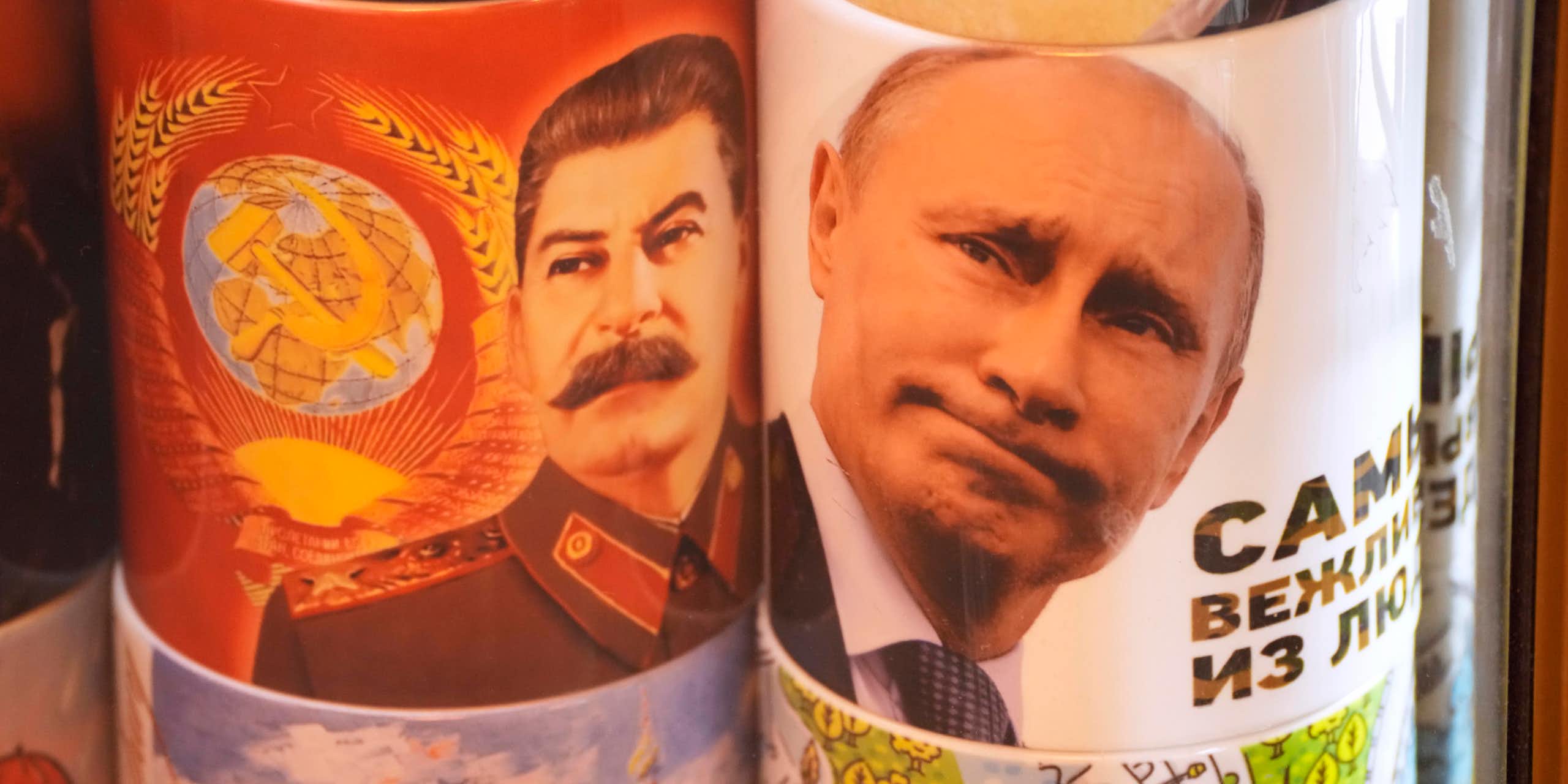 Two cups display the faces of Stalin and Putin.