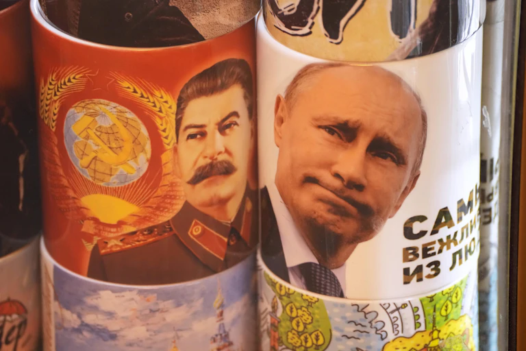Two cups display the faces of Stalin and Putin.