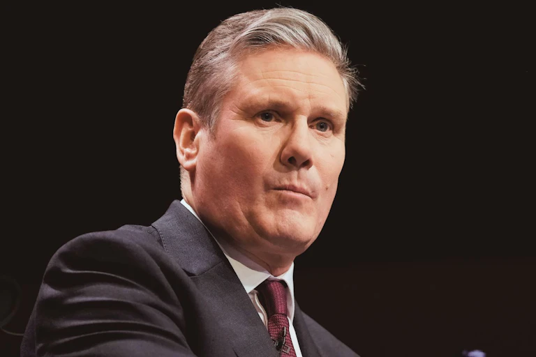 Starmer delivers a speech to an audience.