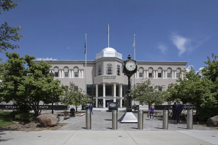 A large gray building with a silver dome on top.