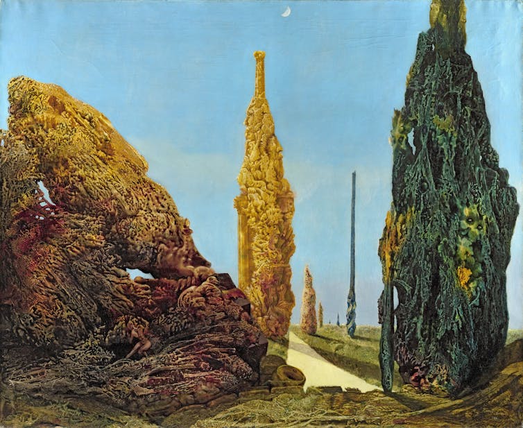 Paintings of bizarre looking greenish, yellowish and brownish trees against a pale blue sky.