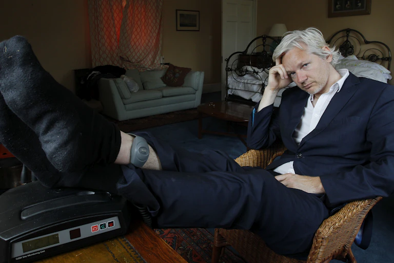 Julian Assange is seen with his ankle security tag at a house in England
