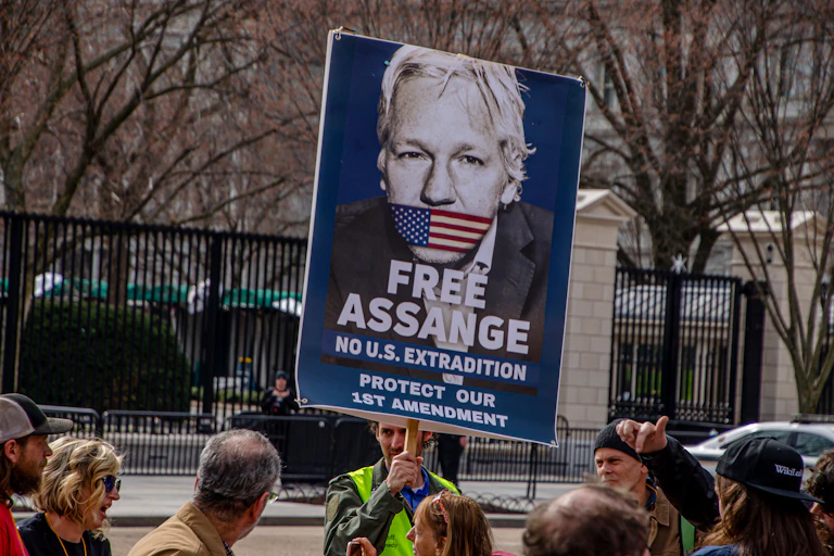 A sign depicts Assange with his mouth taped over