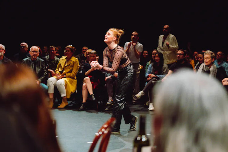 An actor surrounded by the audience.