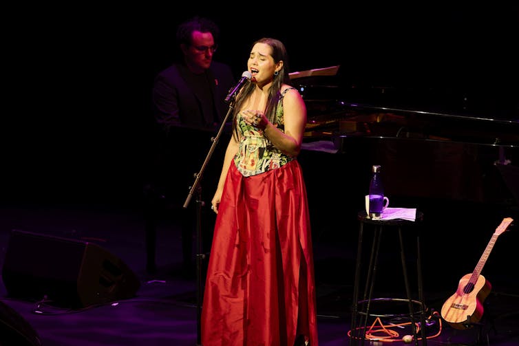 A woman sings on stage.