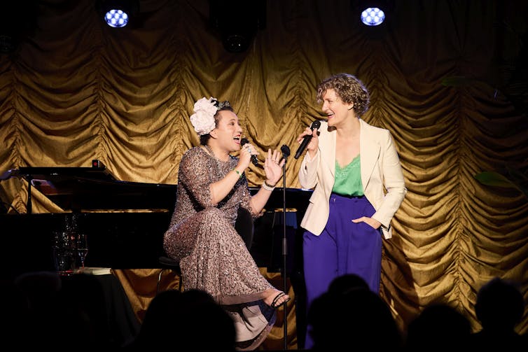 Two women sing.