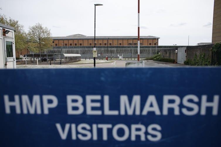 A sign that says HMP BELMARSH VISITORS in front of a prison