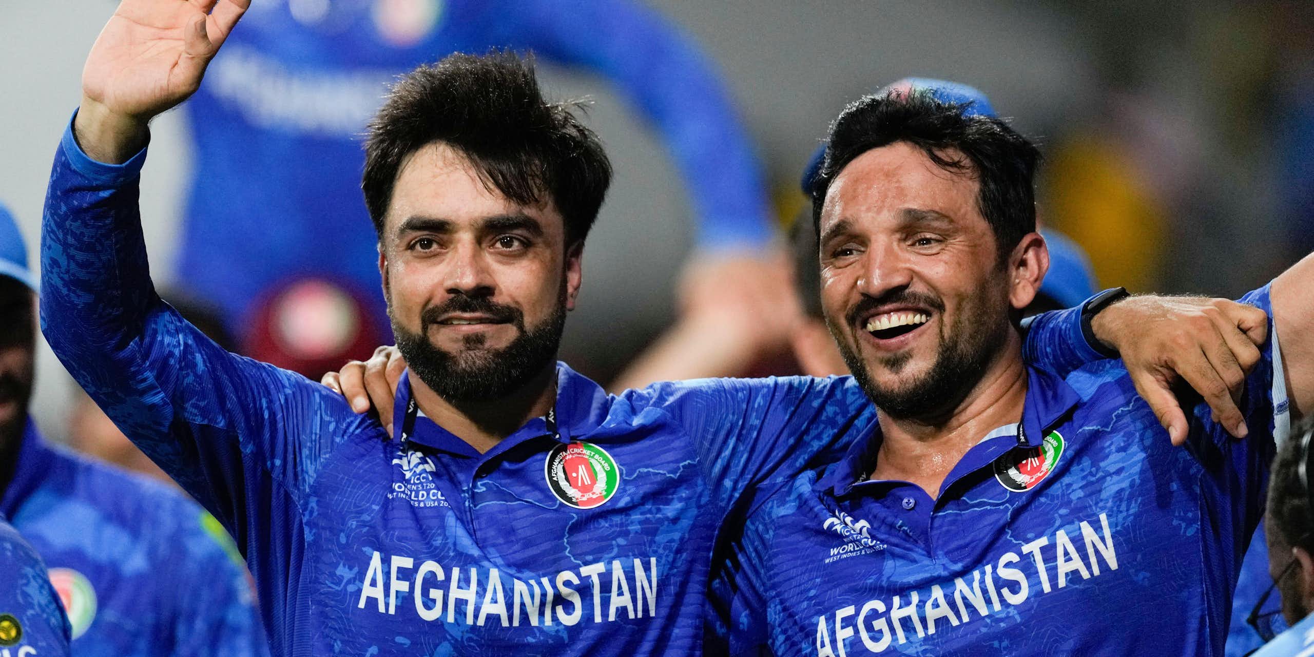 Two Afghan cricketers celebrate victory in the 20204 men's world cup