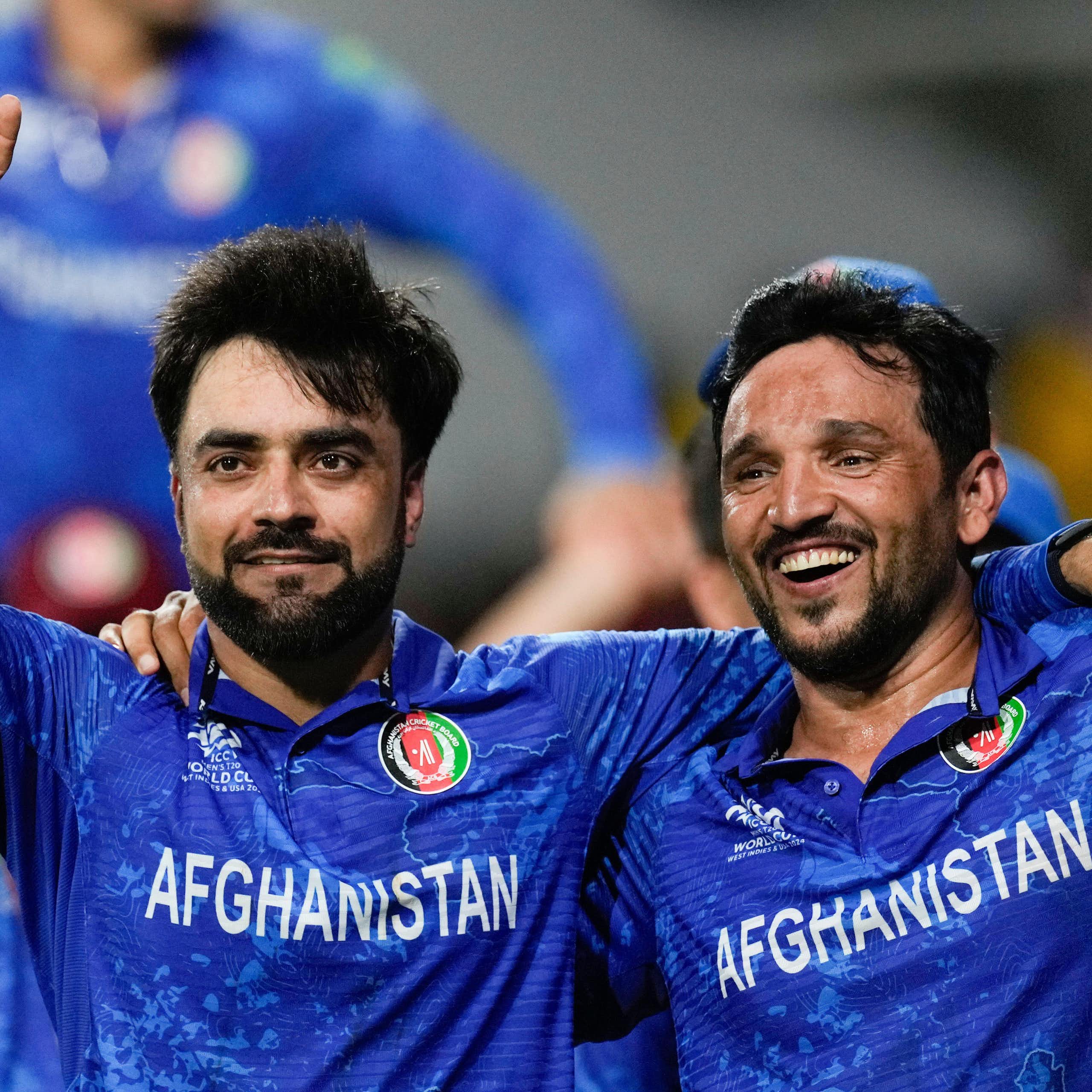 Two Afghan cricketers celebrate victory in the 20204 men's world cup