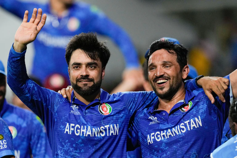 Two Afghan cricketers celebrate victory in the 20204 men's world cup
