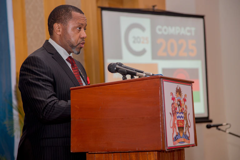 Man in suit and tie standing at a podium