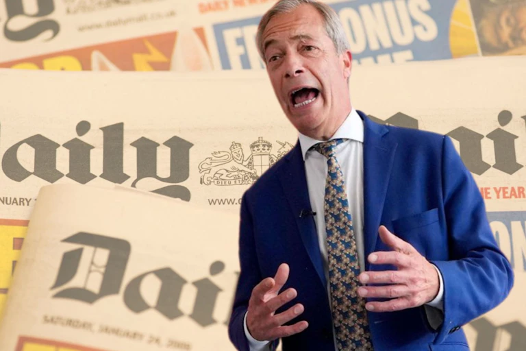 Nigel Farage delivering a speech against a background of Daily Mail newspapers.