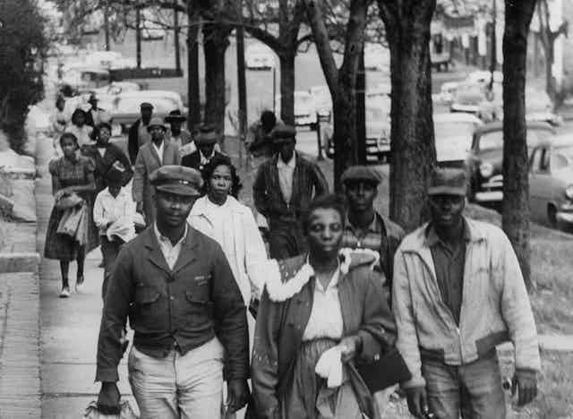 A group of Black people are walking to work to protest racial segregation.