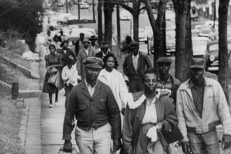 A group of Black people are walking to work to protest racial segregation.