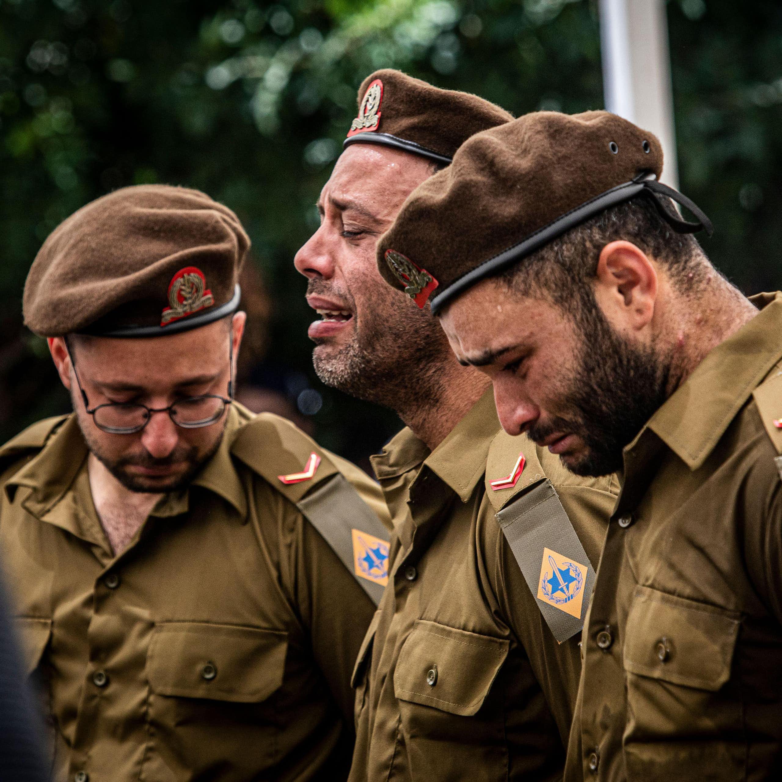 Members of the Israel Defense Forces weep at the funeral of a comrade.