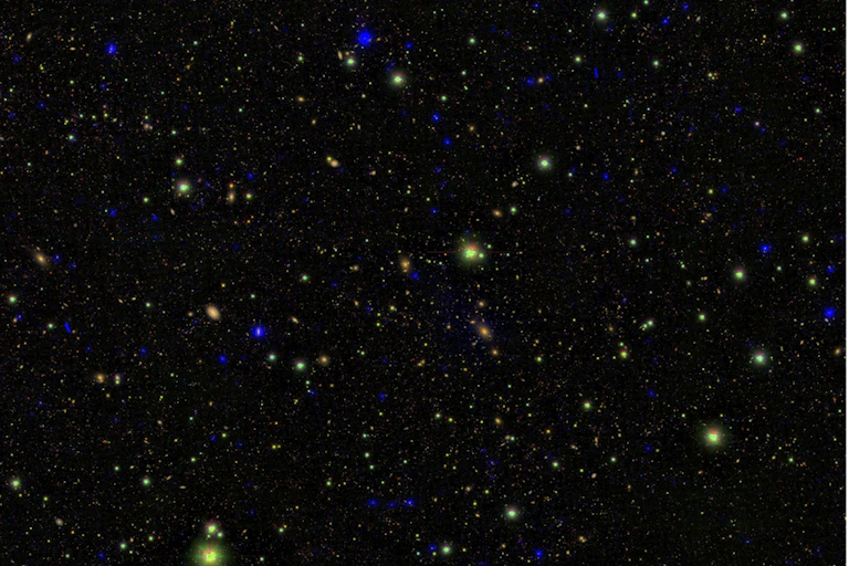 Small blue, red and green dots against a dark sky.