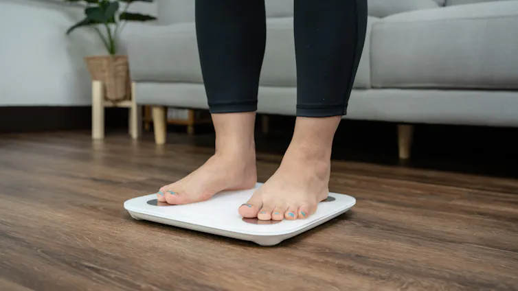 Woman stands on scales