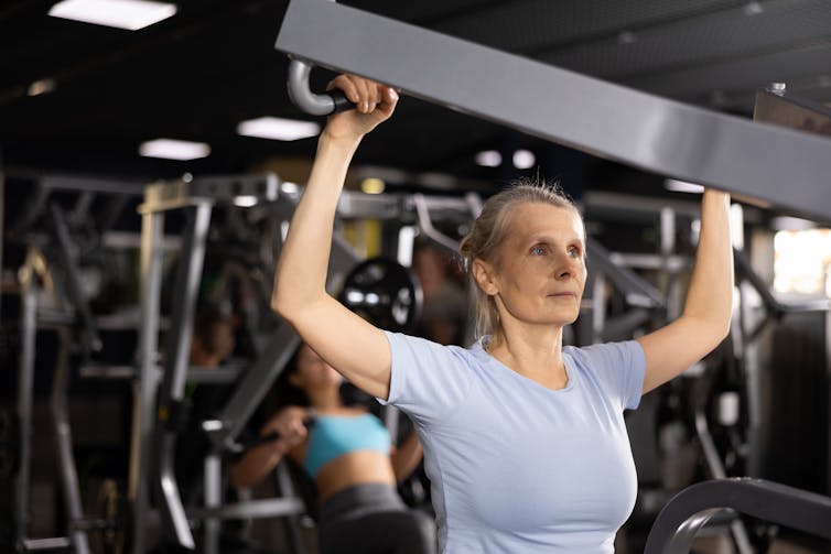Woman uses weights at the gym