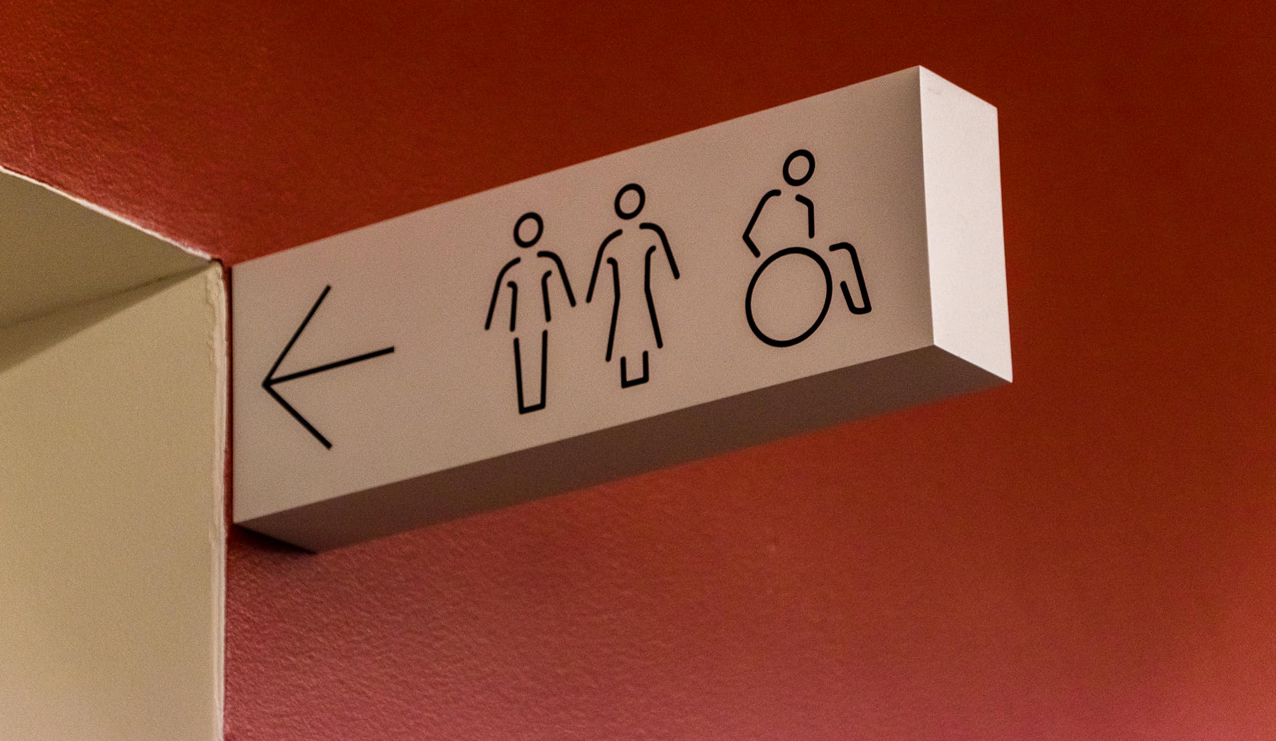 A sign pointing towards men's, women's and disabled restrooms