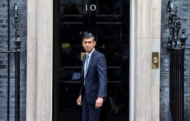 Rishi Sunak stands in front of 10 Downing Street