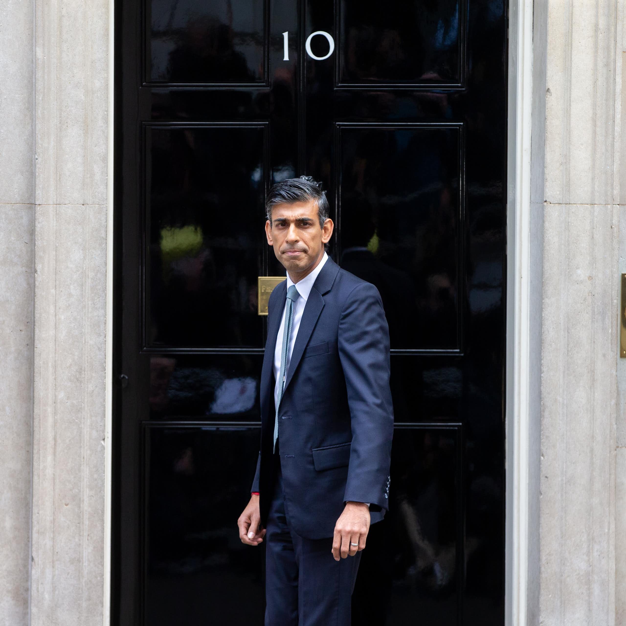 Rishi Sunak stands in front of 10 Downing Street