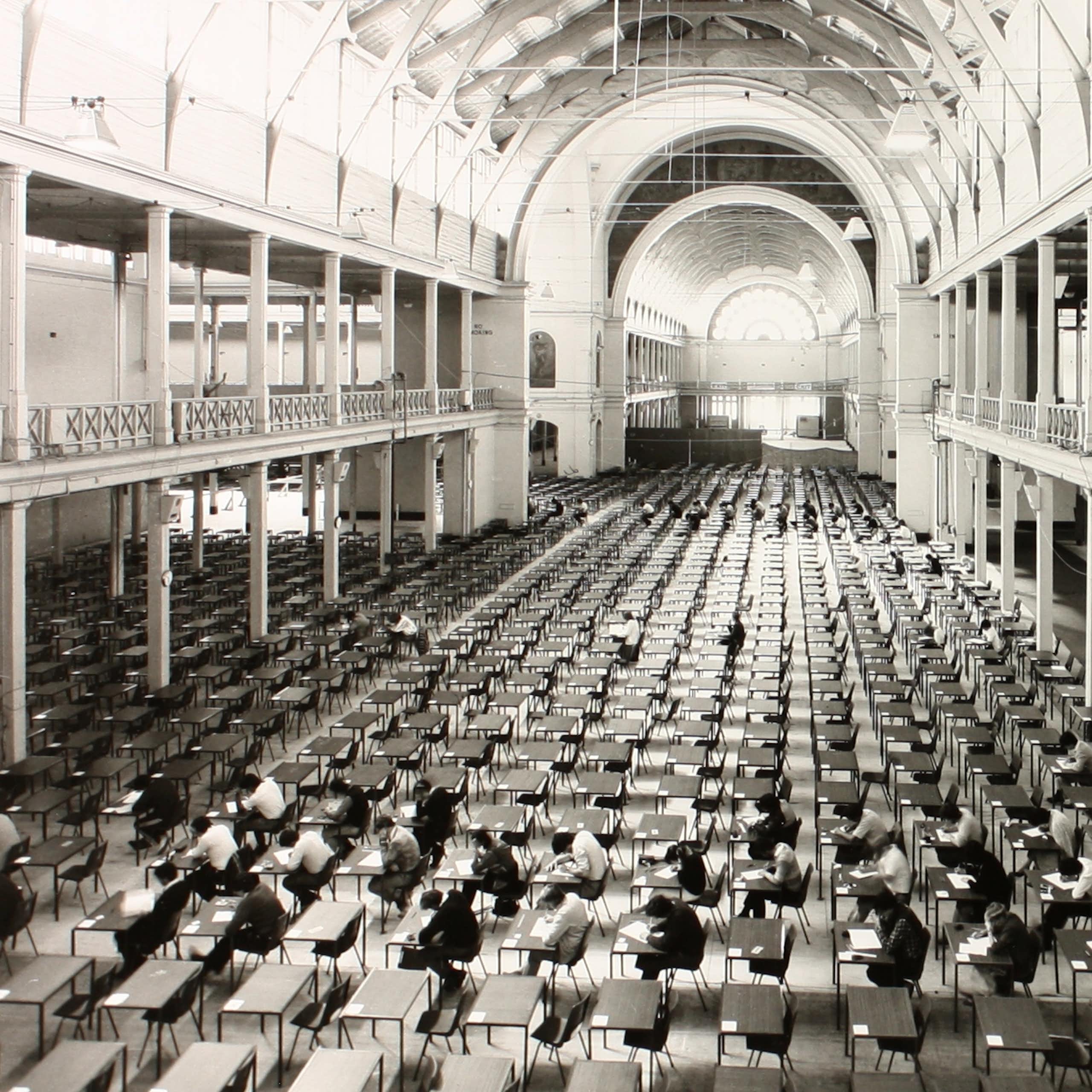 Large room with rows of tables and chairs for an examination