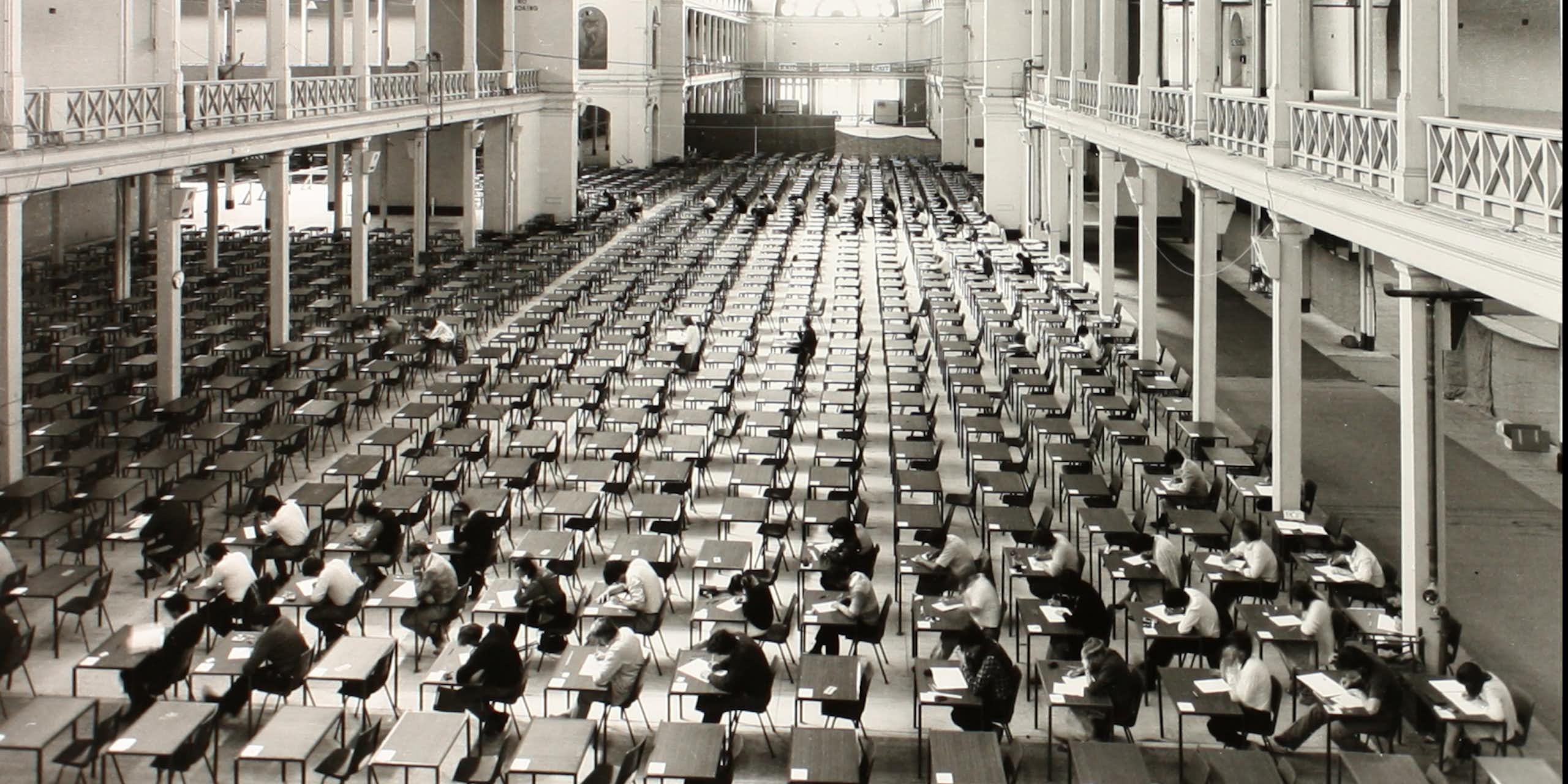 Large room with rows of tables and chairs for an examination
