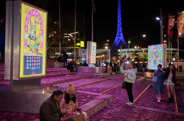 People take photos of art in Fed Sq.