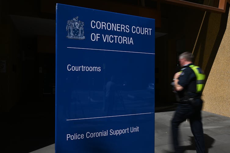 A policeman walks into the coroners court of victoria.