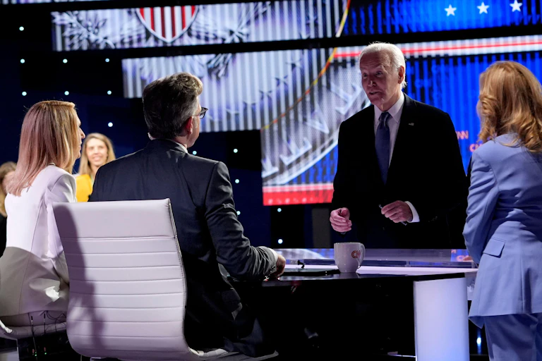 Joe Biden speaks to the host at the TV debate where he clashed with Donald Trump.