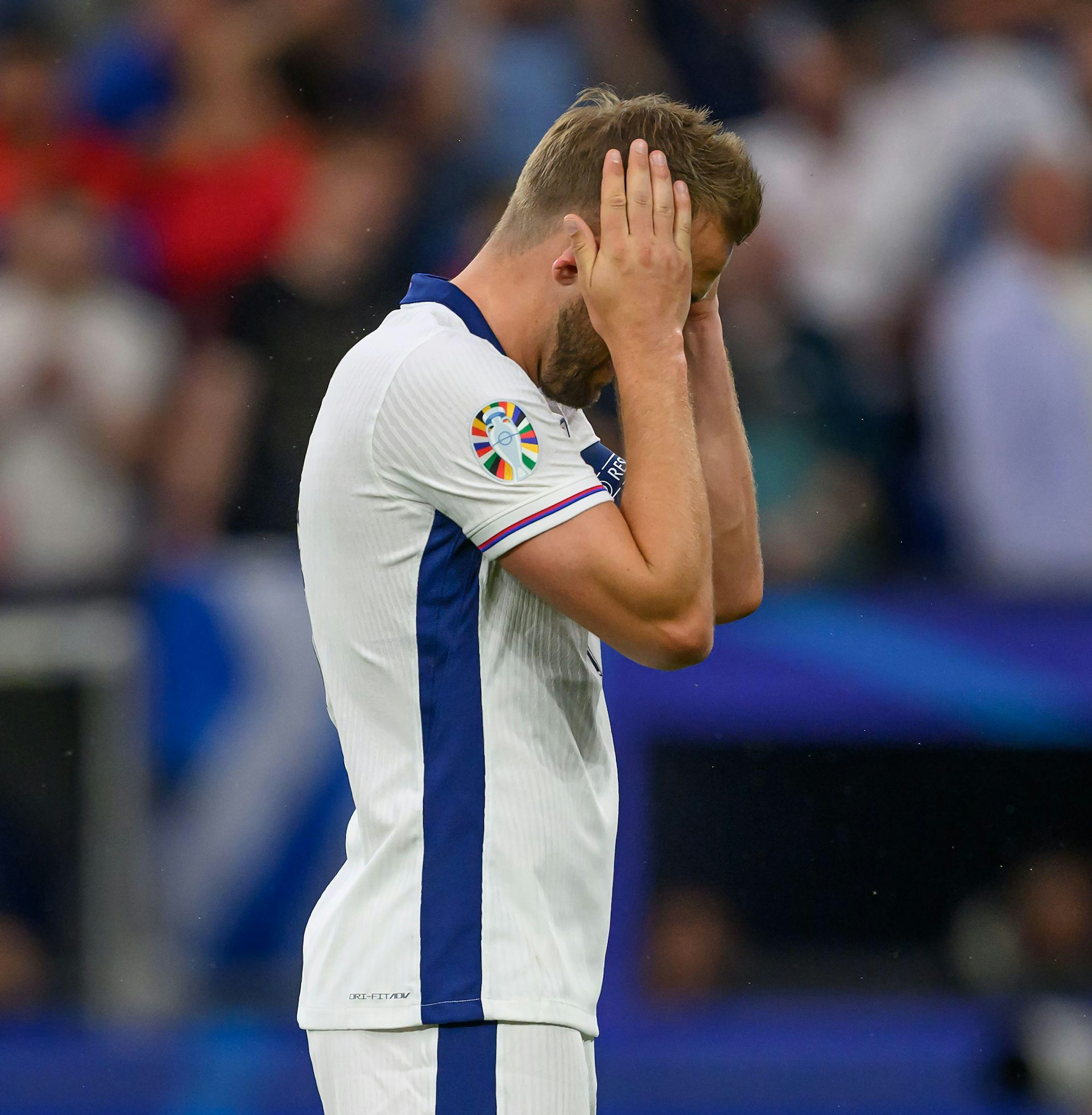 England footballer Harry Kane with his head in his hands at a Euro 2024 match.