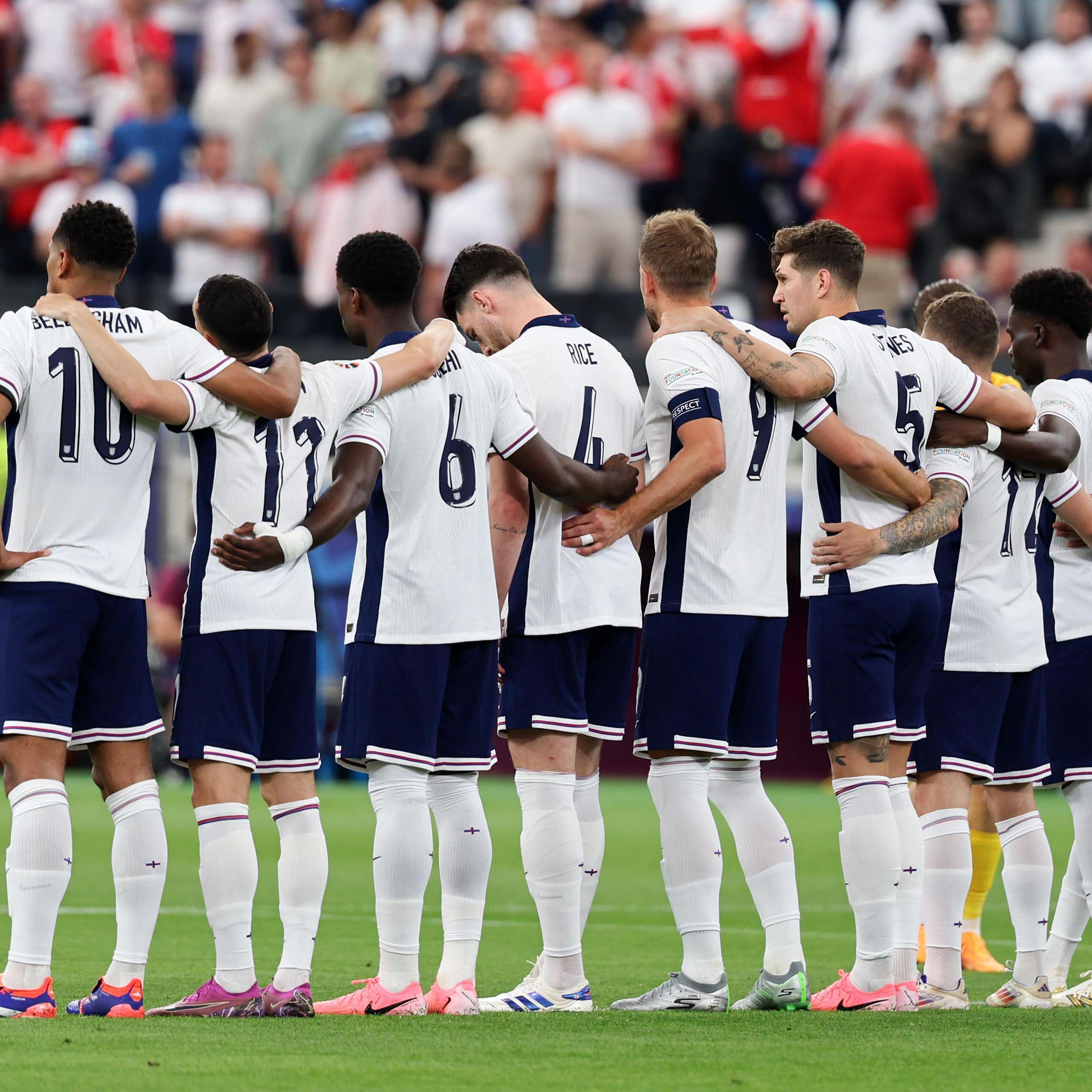 The England team seen from behind lined up with arms linked before a match at EEuro 2024.