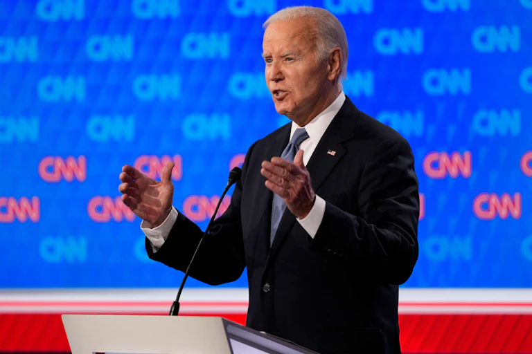 Joe Biden in front of a microphone.