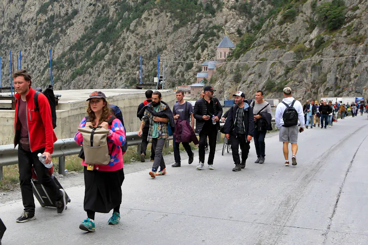 Young Russians walking all a road.