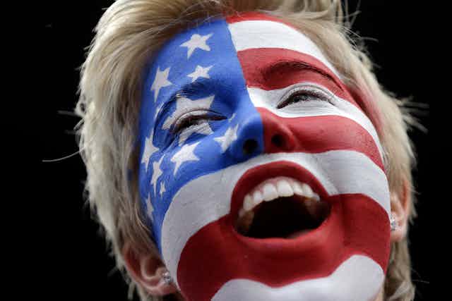 A blonde woman's face, covered in the red, white and blue of the American flag.