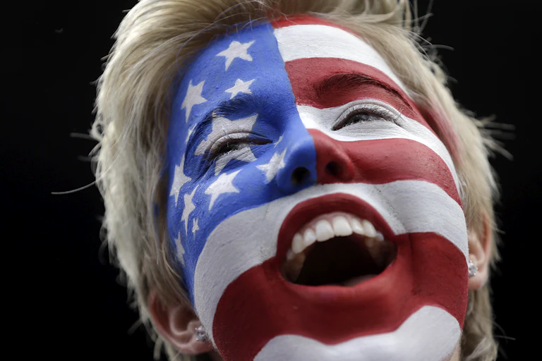 A blonde woman's face, covered in the red, white and blue of the American flag.