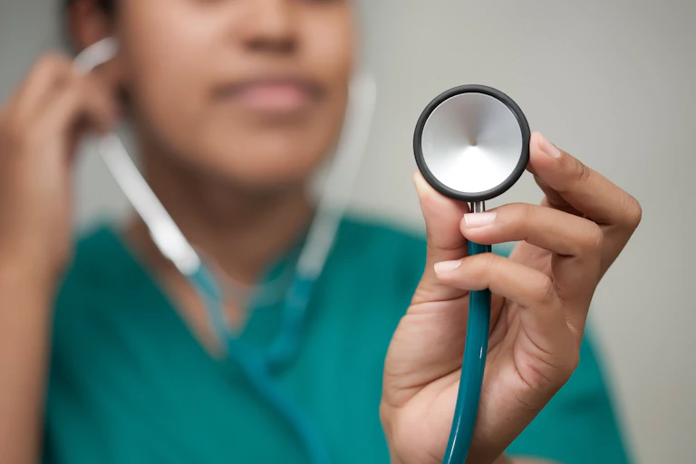 A female healthcare professional taking a reading using a stethoscope