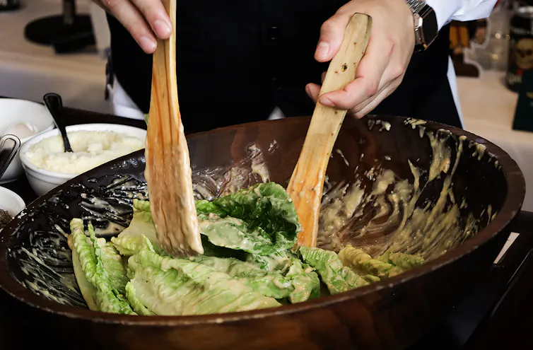 A salad being tossed.