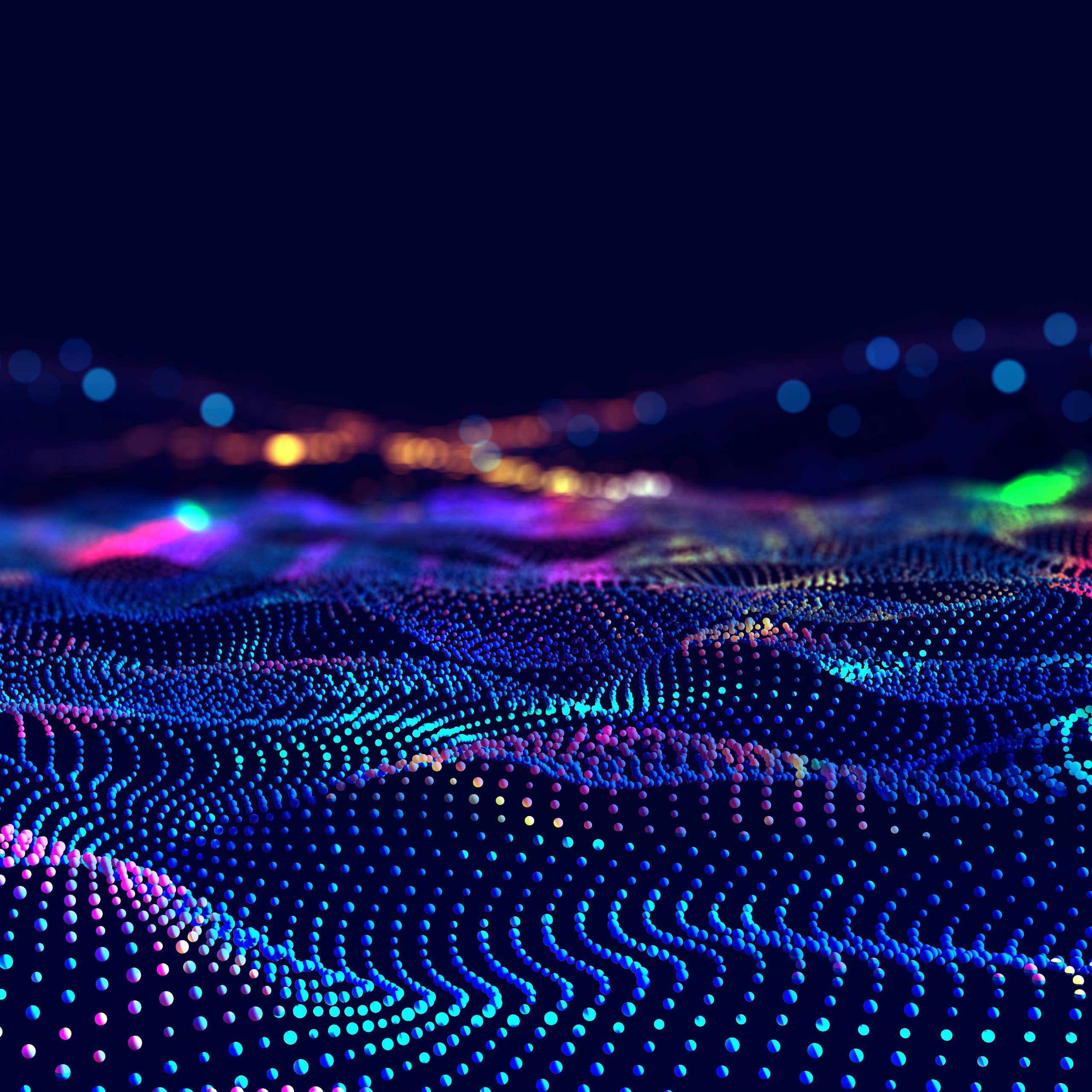 Abstract image of waves of coloured dots against a black background.
